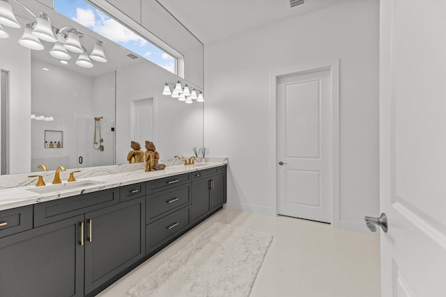 bathroom with vanity and a shower with shower door