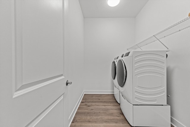 laundry area featuring washer / dryer and light wood-type flooring