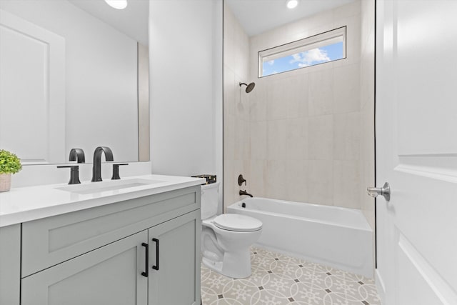 full bathroom featuring vanity, tiled shower / bath combo, tile patterned floors, and toilet