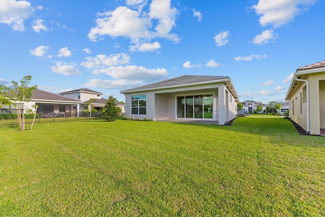 back of property featuring a yard