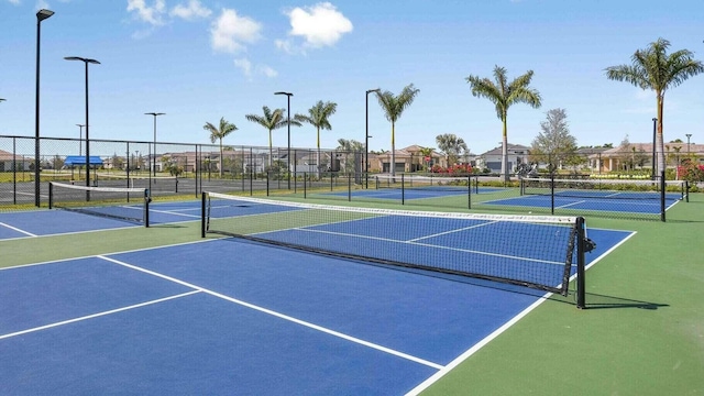 view of tennis court featuring basketball hoop