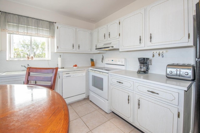 kitchen with ventilation hood, white appliances, light tile patterned floors, and white cabinets