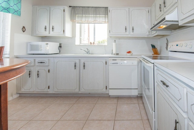 kitchen featuring light tile patterned flooring, tasteful backsplash, white cabinets, white appliances, and sink