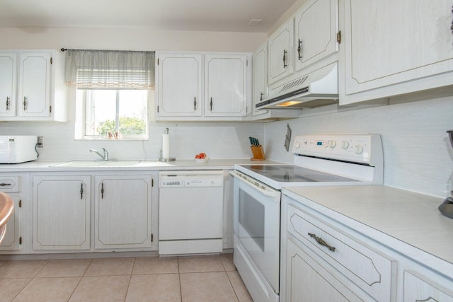 kitchen with sink, white cabinetry, backsplash, white appliances, and light tile patterned floors