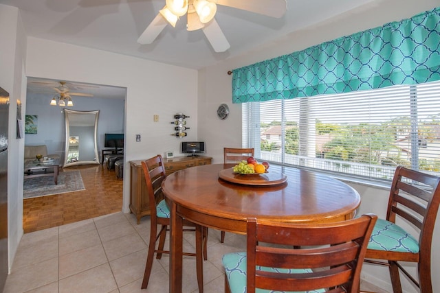 dining space with light parquet floors and ceiling fan