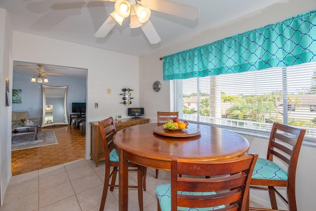 dining area with ceiling fan and light parquet floors