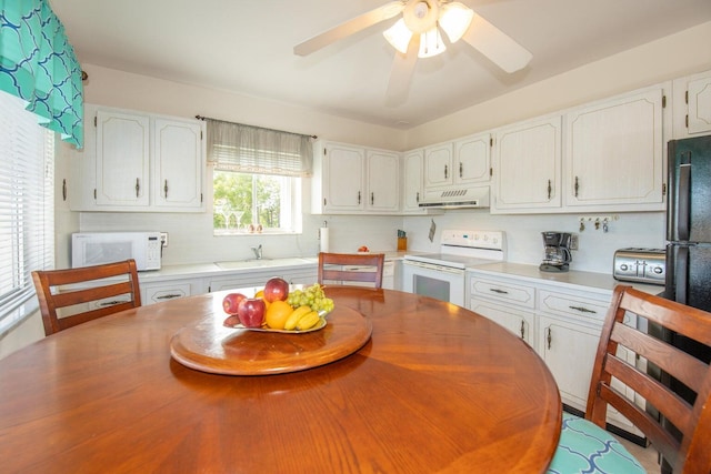 kitchen with white cabinets, white appliances, ceiling fan, and extractor fan