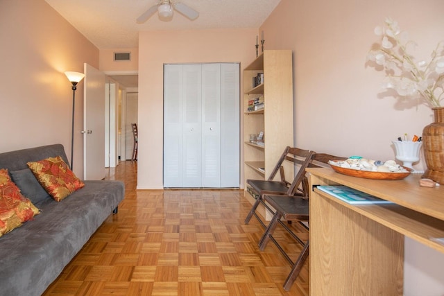 office space with ceiling fan, light parquet floors, and a textured ceiling