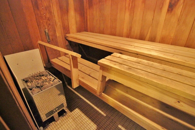 view of sauna featuring wooden walls