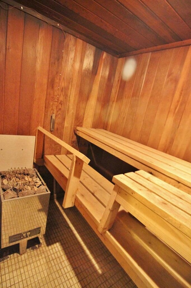 view of sauna / steam room featuring wood ceiling and wood walls