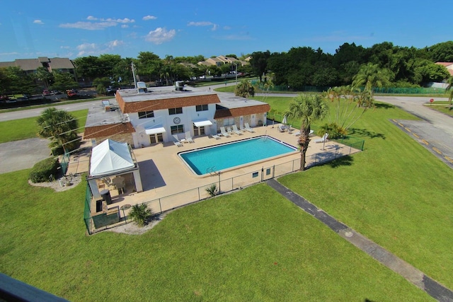 view of pool with a patio and a yard