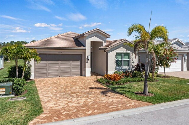 view of front of property with a front yard and a garage