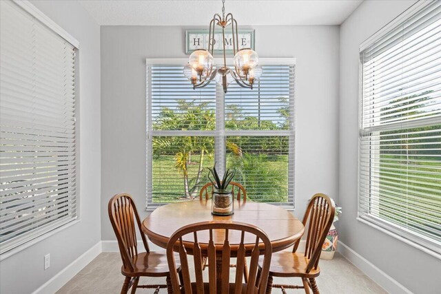 dining area featuring a notable chandelier and a wealth of natural light