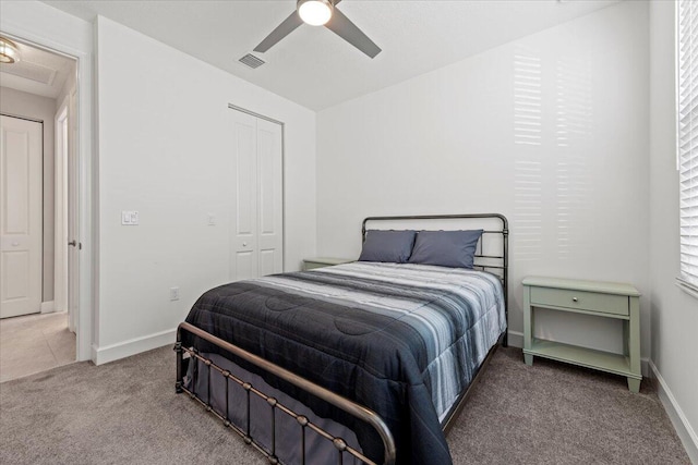 carpeted bedroom with ceiling fan and a closet