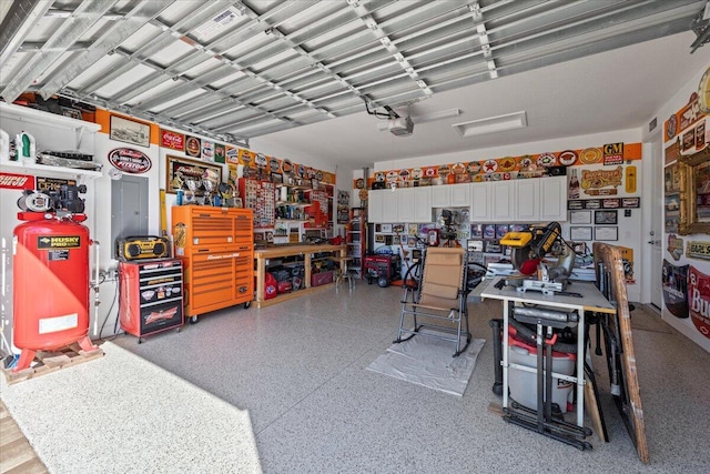 garage featuring a garage door opener and a workshop area