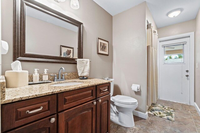 bathroom featuring tiled bath, vanity, tile patterned floors, and a wealth of natural light