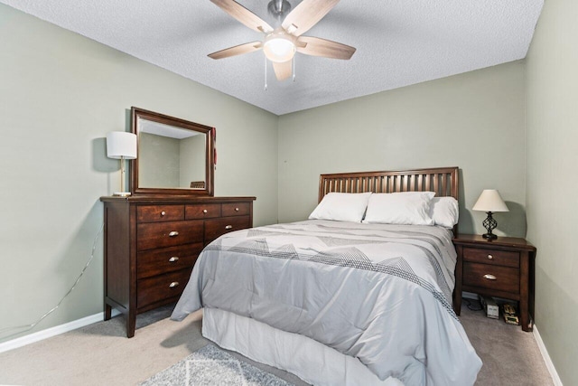 office area with carpet floors, a textured ceiling, and ceiling fan