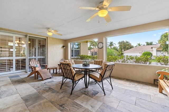 dining space featuring ceiling fan and a textured ceiling