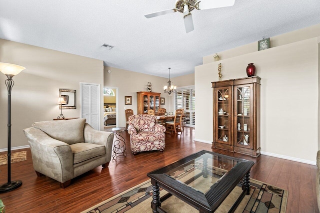 living room featuring a textured ceiling, ceiling fan, and dark hardwood / wood-style flooring