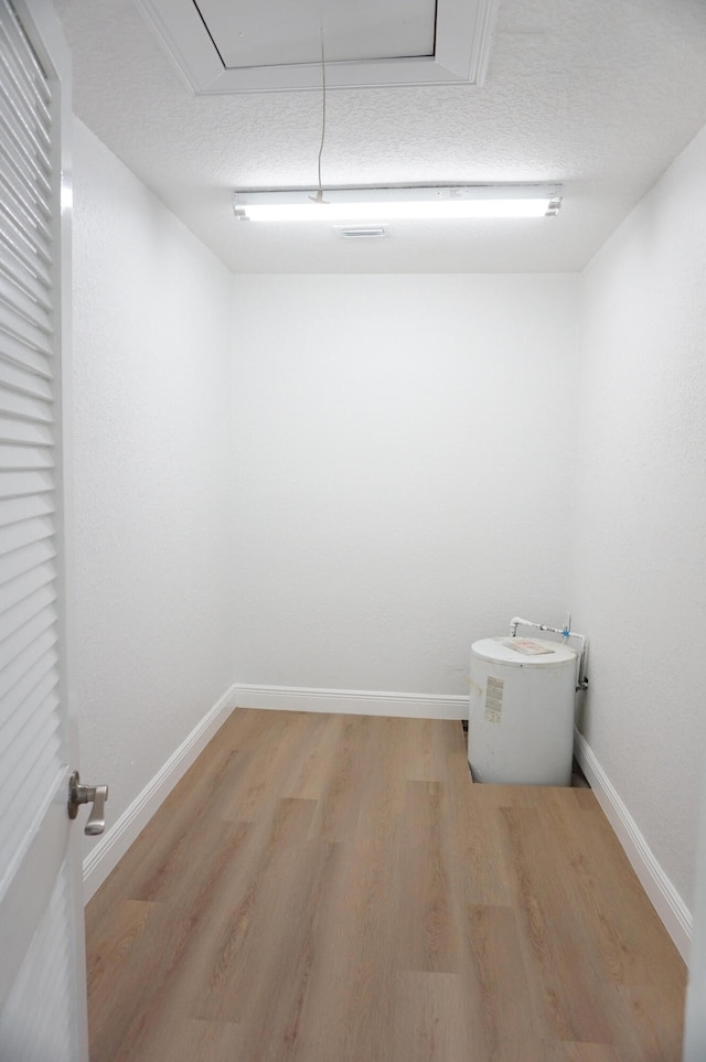 bathroom with hardwood / wood-style floors and a textured ceiling