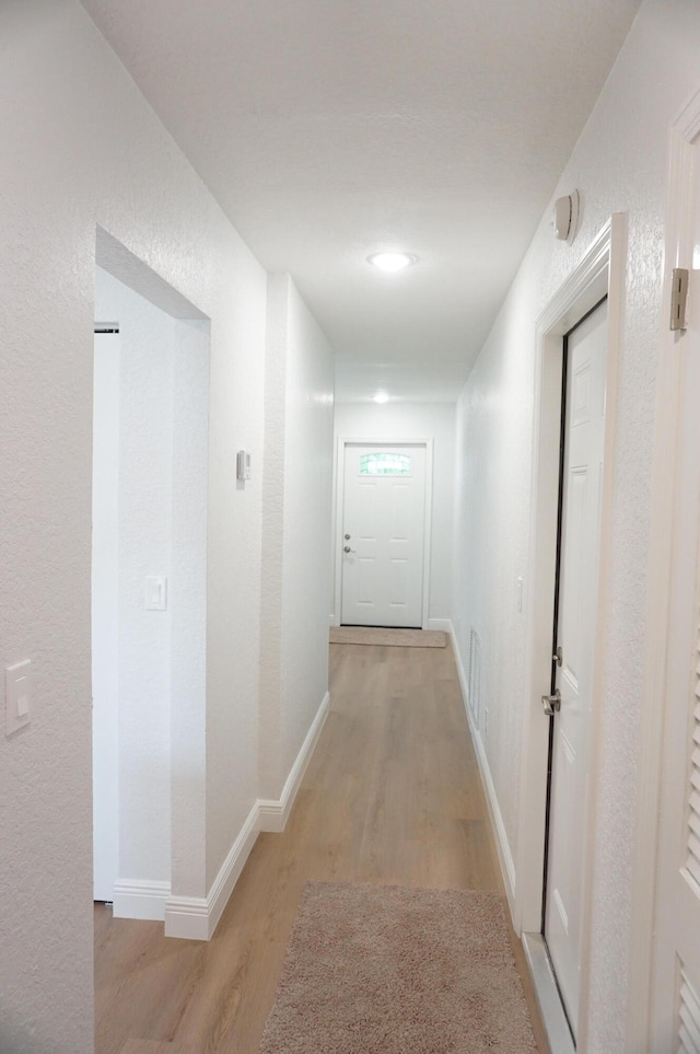 corridor with light wood-type flooring