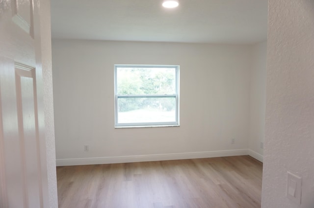 unfurnished room with light hardwood / wood-style flooring