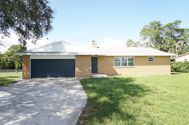 single story home featuring a garage and a front lawn