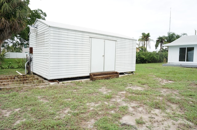 view of outbuilding featuring a lawn