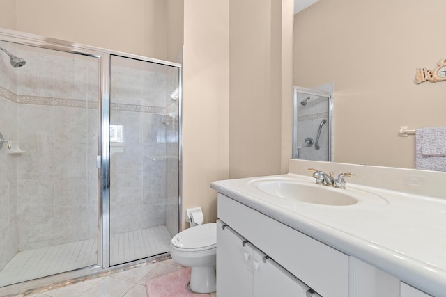 bathroom featuring vanity, a shower with shower door, toilet, and tile patterned floors