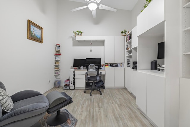 office space featuring high vaulted ceiling, light hardwood / wood-style floors, and ceiling fan