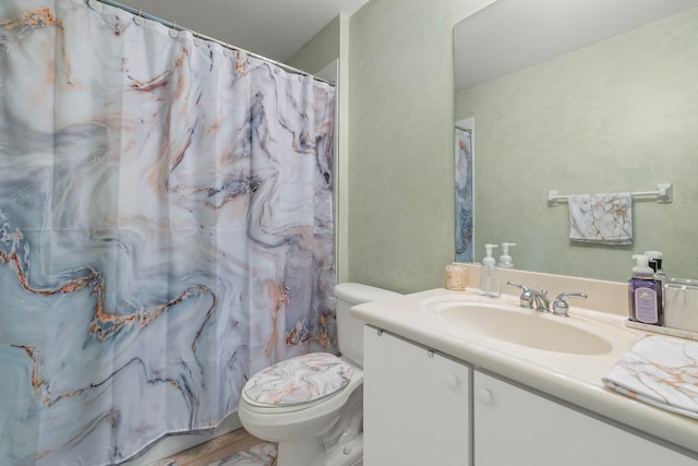 bathroom with curtained shower, hardwood / wood-style flooring, vanity, and toilet