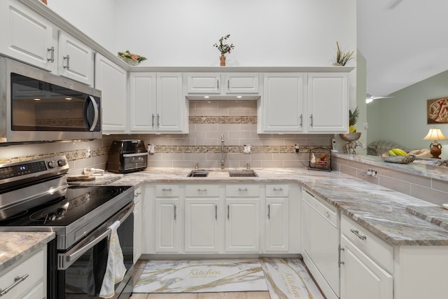 kitchen featuring white cabinetry, sink, stainless steel appliances, and tasteful backsplash