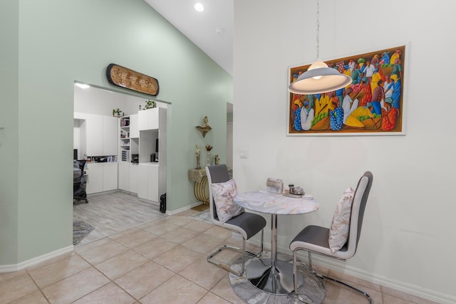 tiled dining room featuring high vaulted ceiling