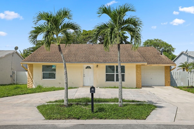 6009 Triphammer Rd, Lake Worth, FL 33463 - ranch-style home with driveway, fence, roof with shingles, stucco siding, and a garage