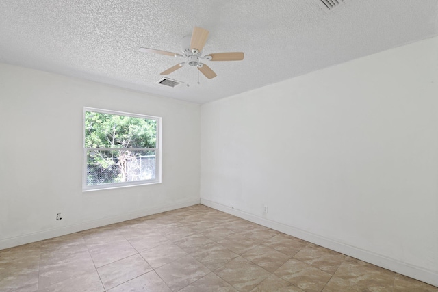 empty room with a textured ceiling and ceiling fan