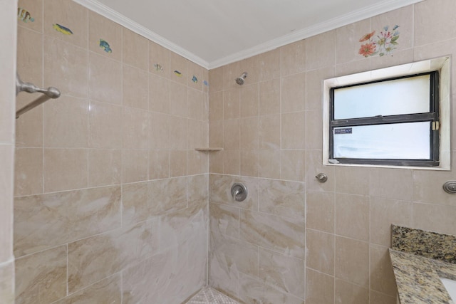 bathroom with ornamental molding and tiled shower