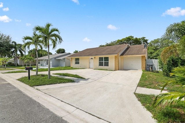 ranch-style home with a garage and a front yard