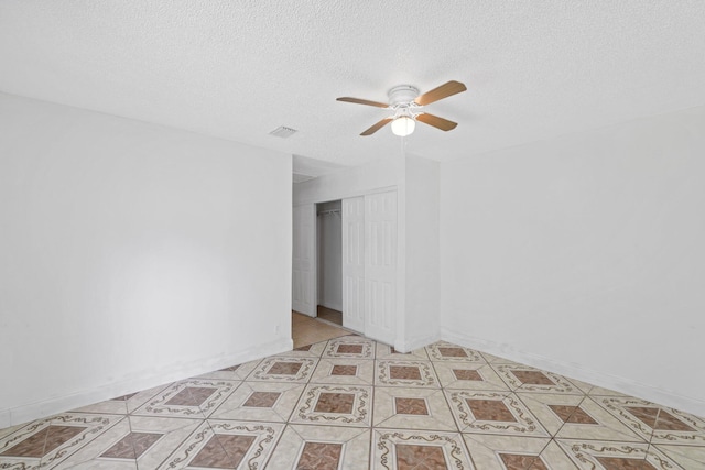 6009 Triphammer Rd, Lake Worth, FL 33463 - empty room featuring a textured ceiling, ceiling fan, and visible vents