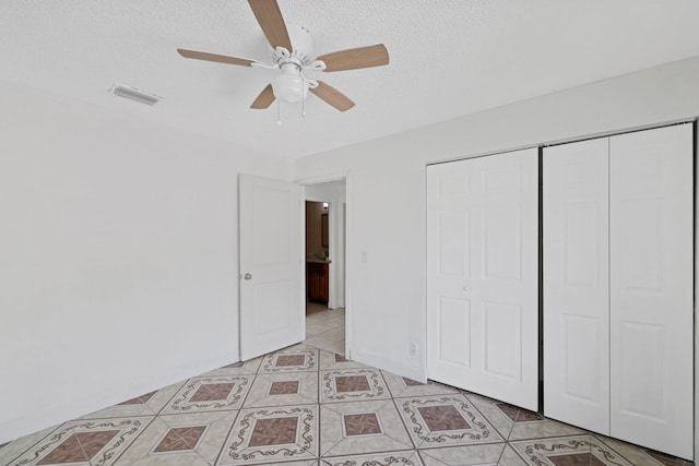 6009 Triphammer Rd, Lake Worth, FL 33463 - unfurnished bedroom with a closet, ceiling fan, visible vents, baseboards, and a textured ceiling