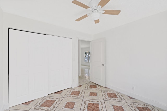 unfurnished bedroom with a closet, ceiling fan, and light tile patterned floors