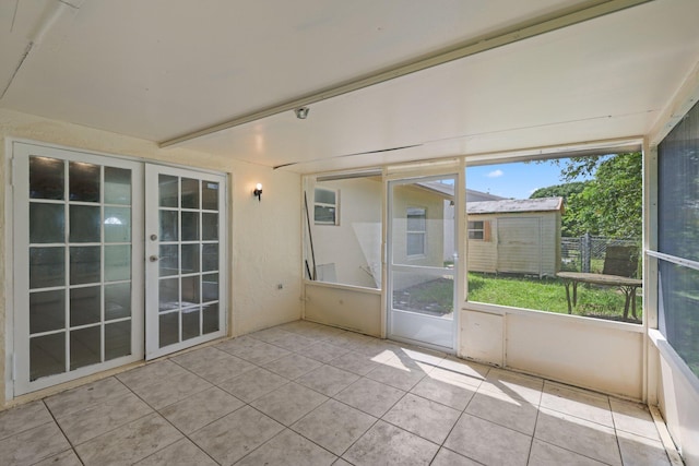 unfurnished sunroom featuring french doors