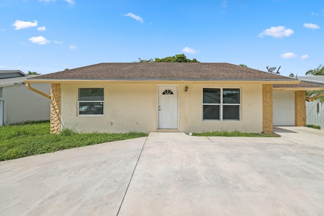 6009 Triphammer Rd, Lake Worth, FL 33463 - ranch-style home featuring roof with shingles, stucco siding, and an attached garage