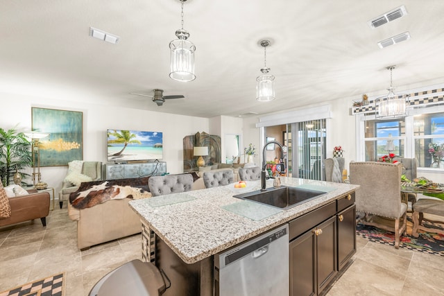 kitchen with sink, dishwasher, ceiling fan, pendant lighting, and a kitchen island with sink