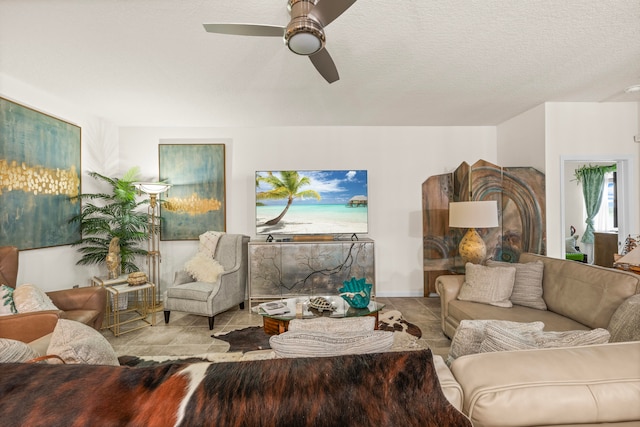 tiled living room featuring a textured ceiling and ceiling fan