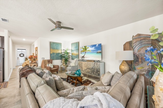 living room with a textured ceiling and ceiling fan