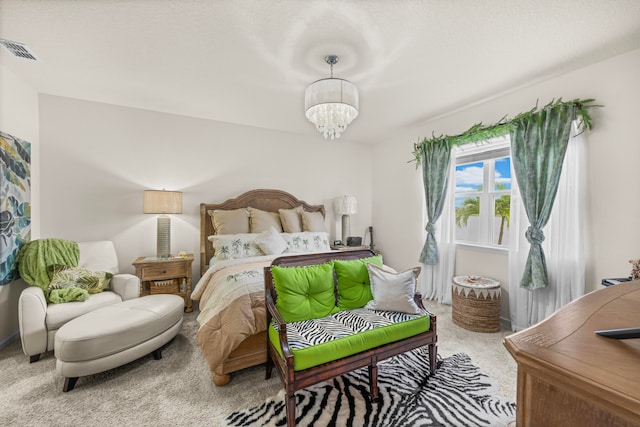 bedroom with carpet and a chandelier