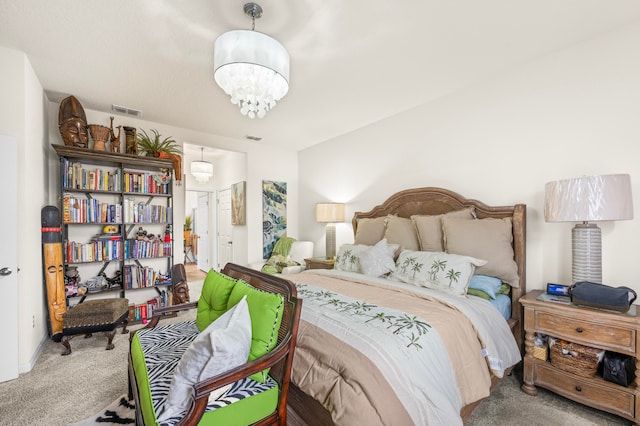 bedroom featuring an inviting chandelier and carpet floors