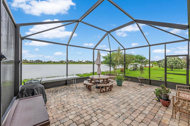 view of patio featuring a water view and a lanai