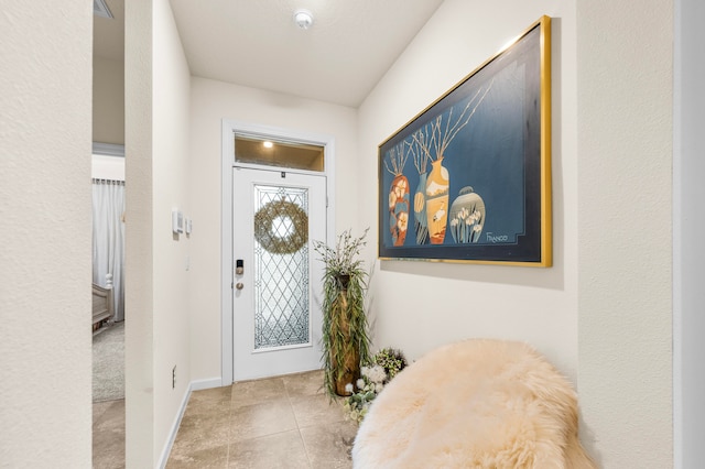 foyer entrance featuring light tile patterned floors