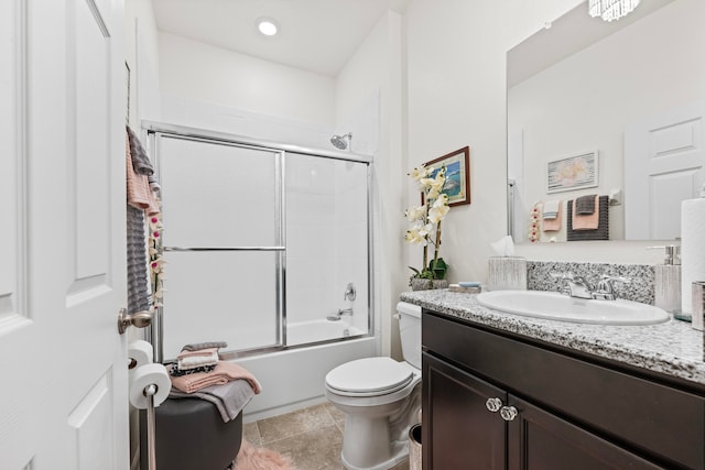 full bathroom with vanity, toilet, combined bath / shower with glass door, and tile patterned flooring